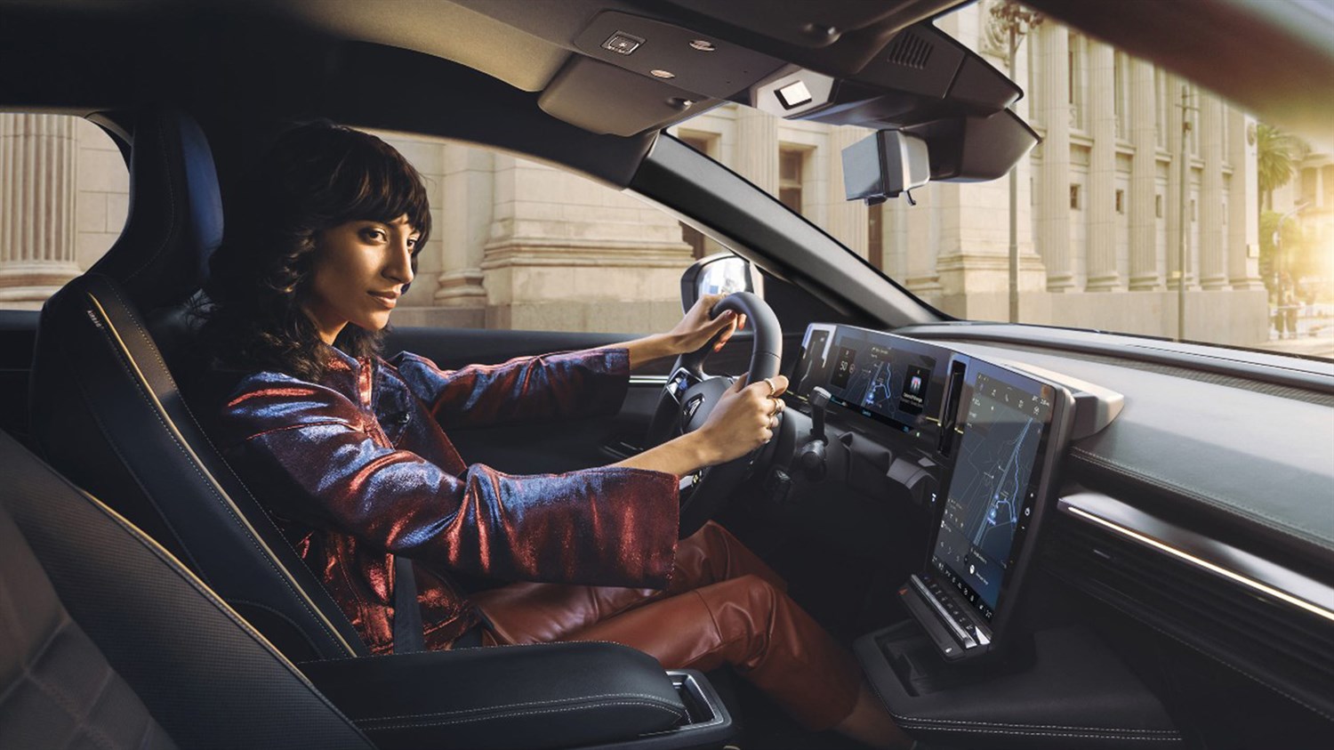 A driver driving his Renault car on the road using the navigation